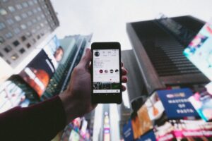 instagram profile on iphone in cityscape