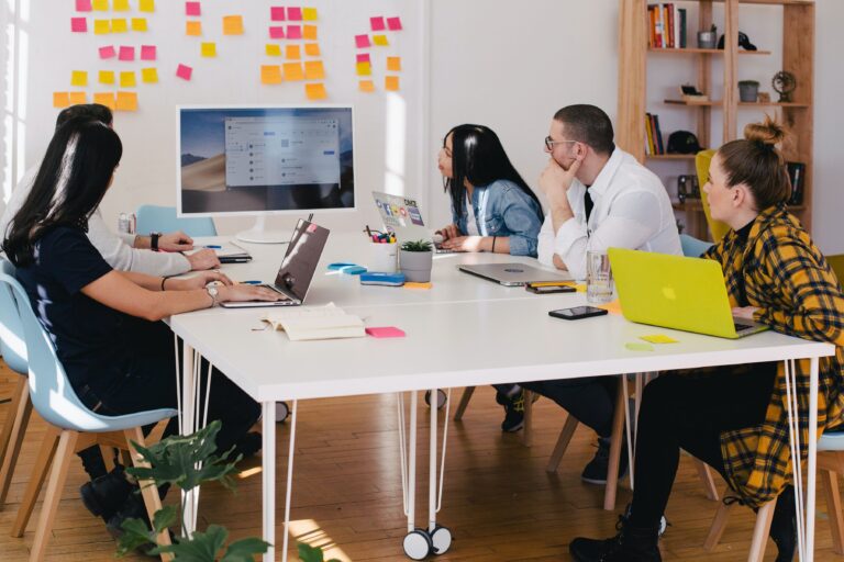 marketing team meeting with marketing strategy on whiteboard