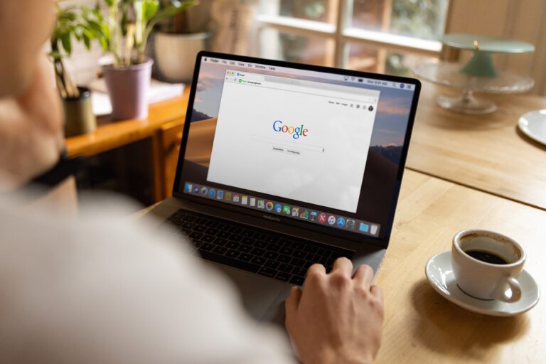 persons hands on a laptop searching on google