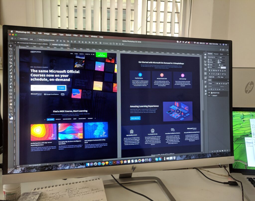 two screens with website designing software on them