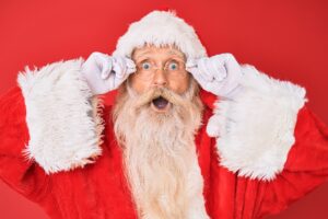 santa with a surprised face and a red background