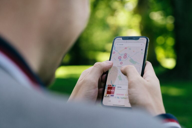 person holding a phone in their hands with google maps on screen